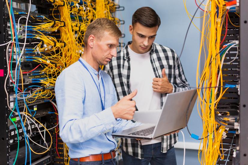 young network engineers with laptop medium shot